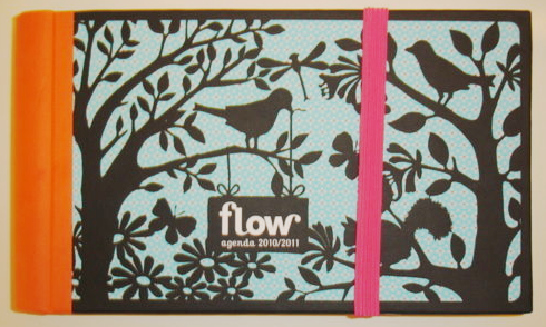 Flow Magazine / Flow Agenda 2010/2011. The cover is orange with black and light blue, and has trees and birds on the cover.