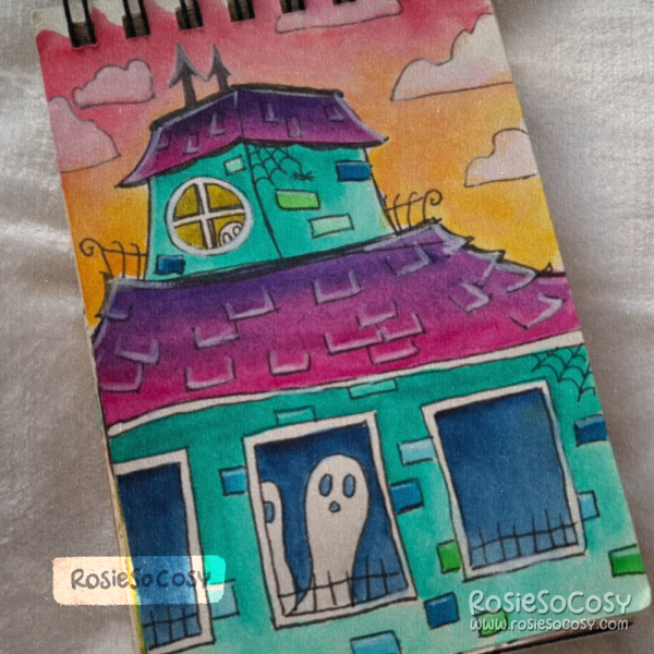 Watercolour illustration of a turquoise haunted house with pinkish purple rooftops, black gothic architectural details, and white ghosts roaming inside the building. The sky is pink and orange, indicating a sunset.