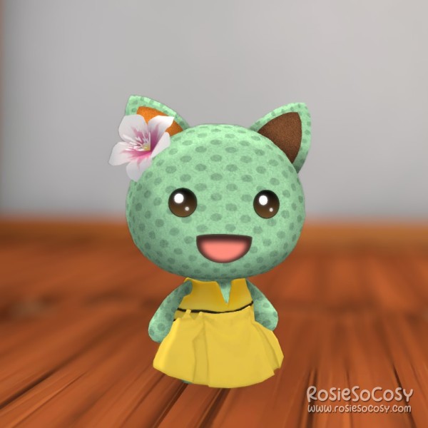 Rosie's character in Garden Paws is a minty green cat, with a dotted pattern all over, and an orange and brown ear. She is wearing a pink flower on her head, a yellow skirt and a yellow life jacket. The yellow items together look like a cute dress.