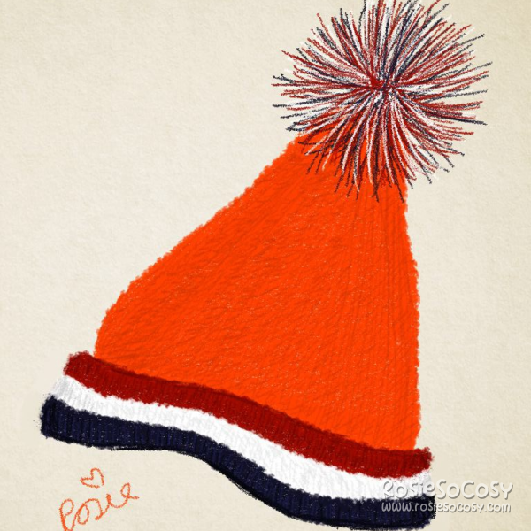 A bright orange knitted Unox winter hat, with the red, white and blue colours of the Dutch flag around it.