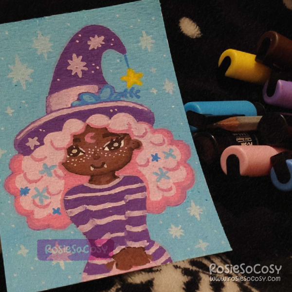 An illustration of a cute witch with a dark skin tone, and very pink hair. She is wearing a purple witch's hat and a similar purple striped shirt. There is a yellow star hanging from her hat.
