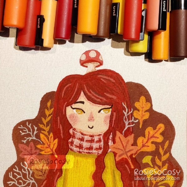 An illustration of a redhead/brunette with rosy cheeks, an ochre jumper and many leaves around her.