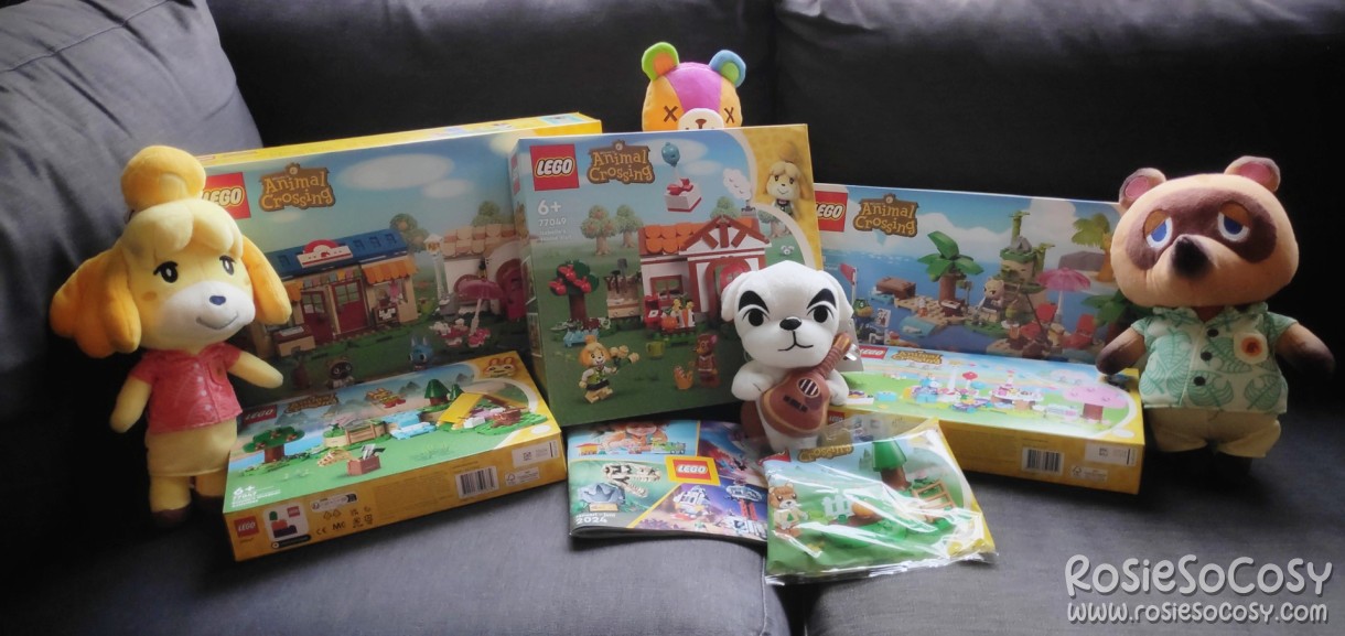 All the Animal Crossing LEGO sets in one picture, with Animal Crossing plushies around it.
