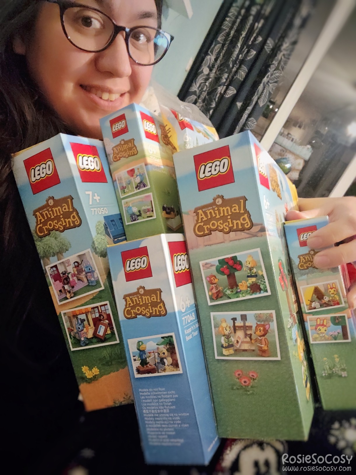 Rosie holding the Animal Crossing LEGO boxes
