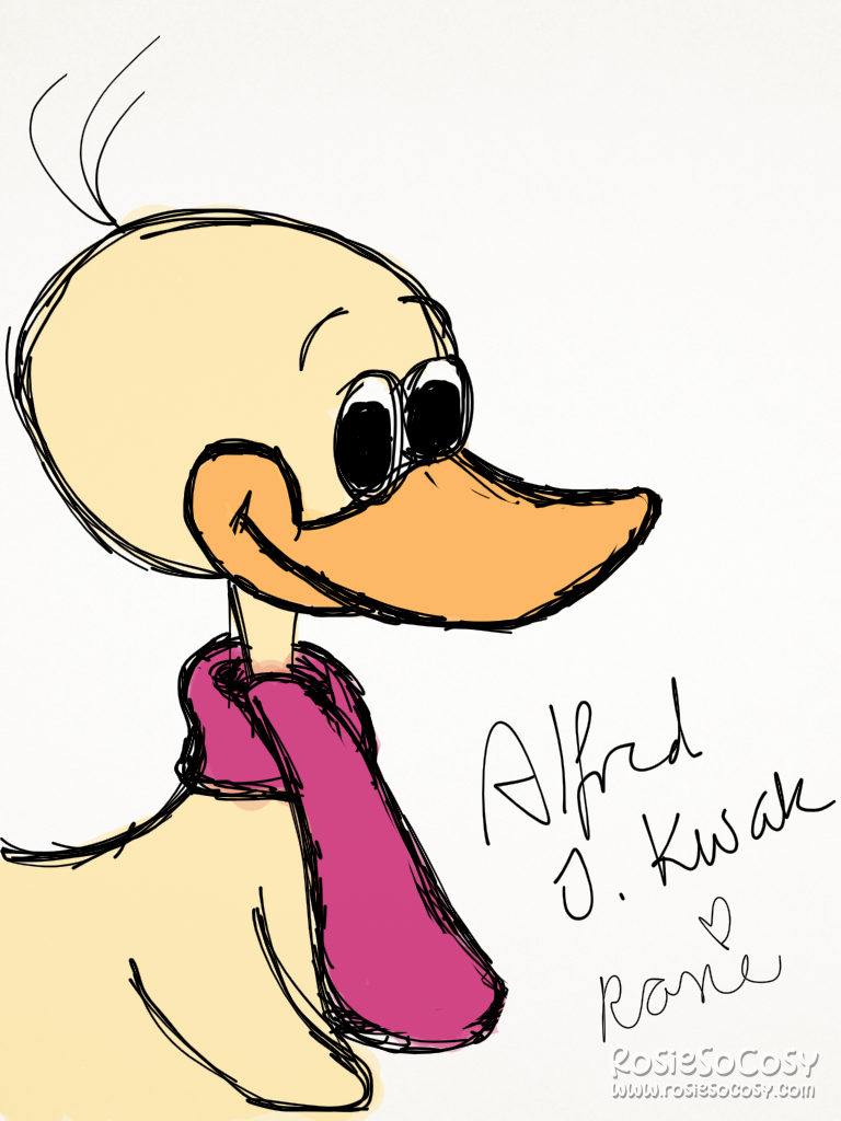 It's Alfred Jodocus Kwak, a yellow duck from a Dutch/Japanese TV show. He's smiling with his orange beak, he has a pink/red scarf around his neck. And there are a few stray hairs sticking out of the back of his head.