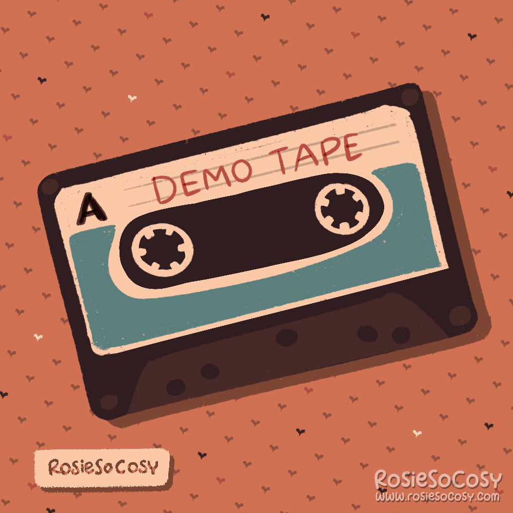 A dark brown/black cassette tape with a creamy white label with blue details, a big black letter “A” in the top left corner and the words “DEMO TAPE” in red on the label.