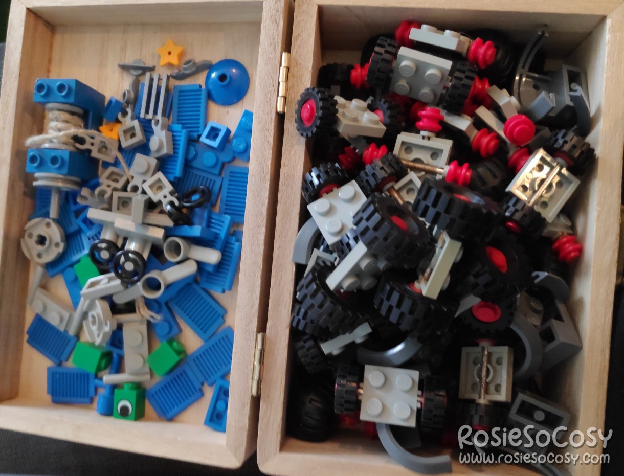 New batch of old LEGO bricks and parts. Smaller parts in a tiny wooden chest. Mostly blues and greens on the left and black and grey wheels on the right.